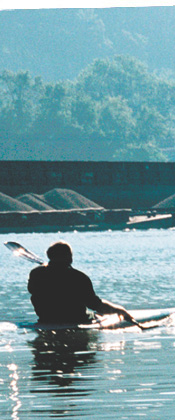 kayaker on the river near coal barges in Allegheny County